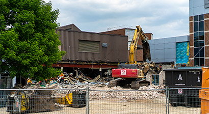 Constructions vehicles and rubble are shown in the exterior of Fanshawe College.