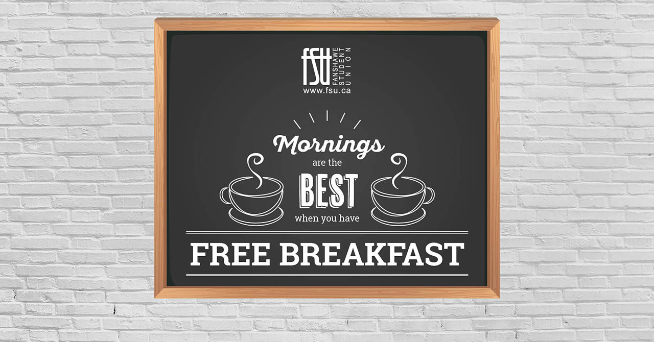 Chalkboard sign with steaming coffee cups reads Mornings are the best when you have free breakfast against a white brick wall.