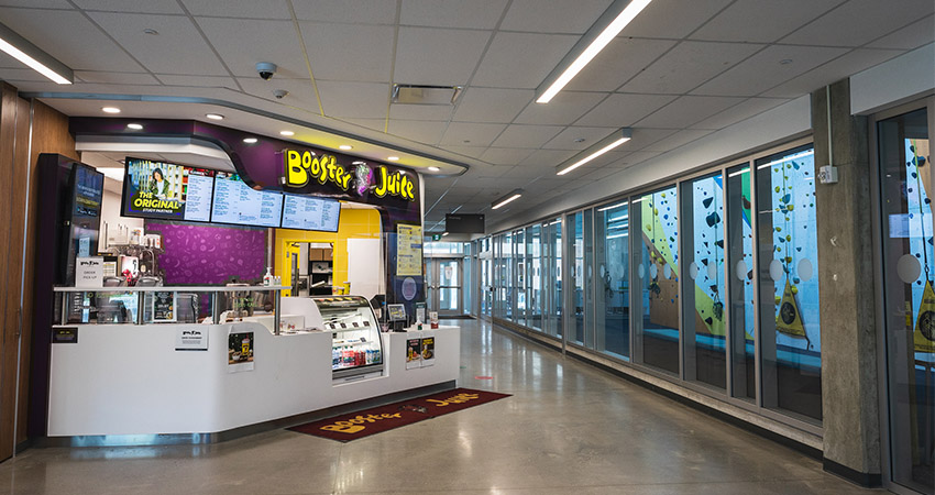 A photo of the Booster Juice at Fanshawe's London Campus next to the rock wall.