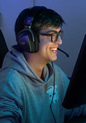 A person smiling, wearing a headset