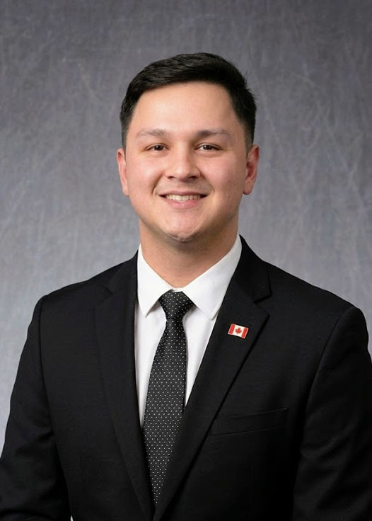 A headshot of Ralph Matthew Cruz in front of a grey background.
