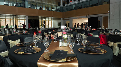 A photo of Forwell Hall in the SUB at Fanshawe College. There are black table clothes on tables and glassware is on display.